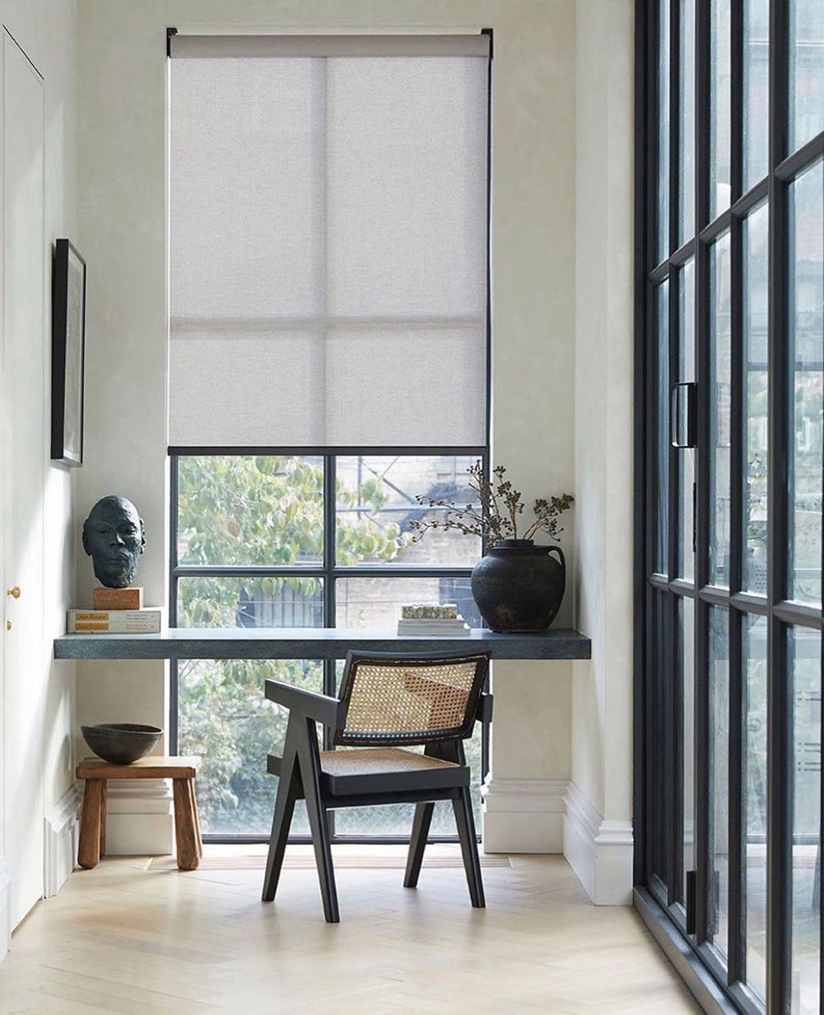 Solar screen shade filtering daylight in a high-window workspace