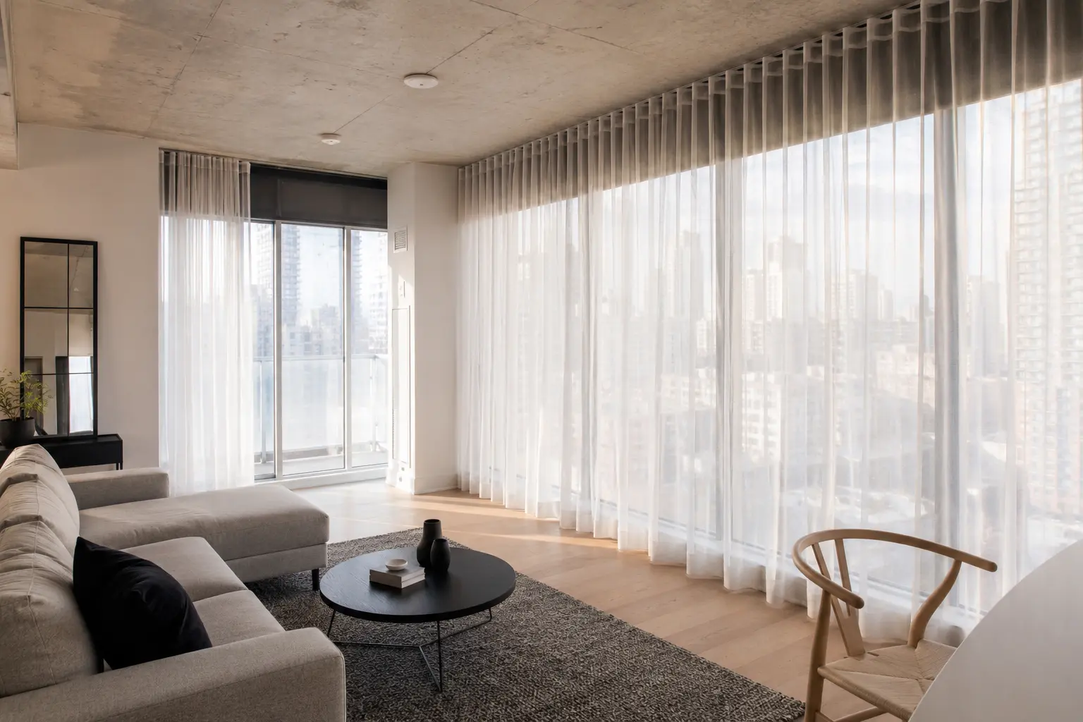 Sheer curtains across floor-to-ceiling windows in a Toronto condo