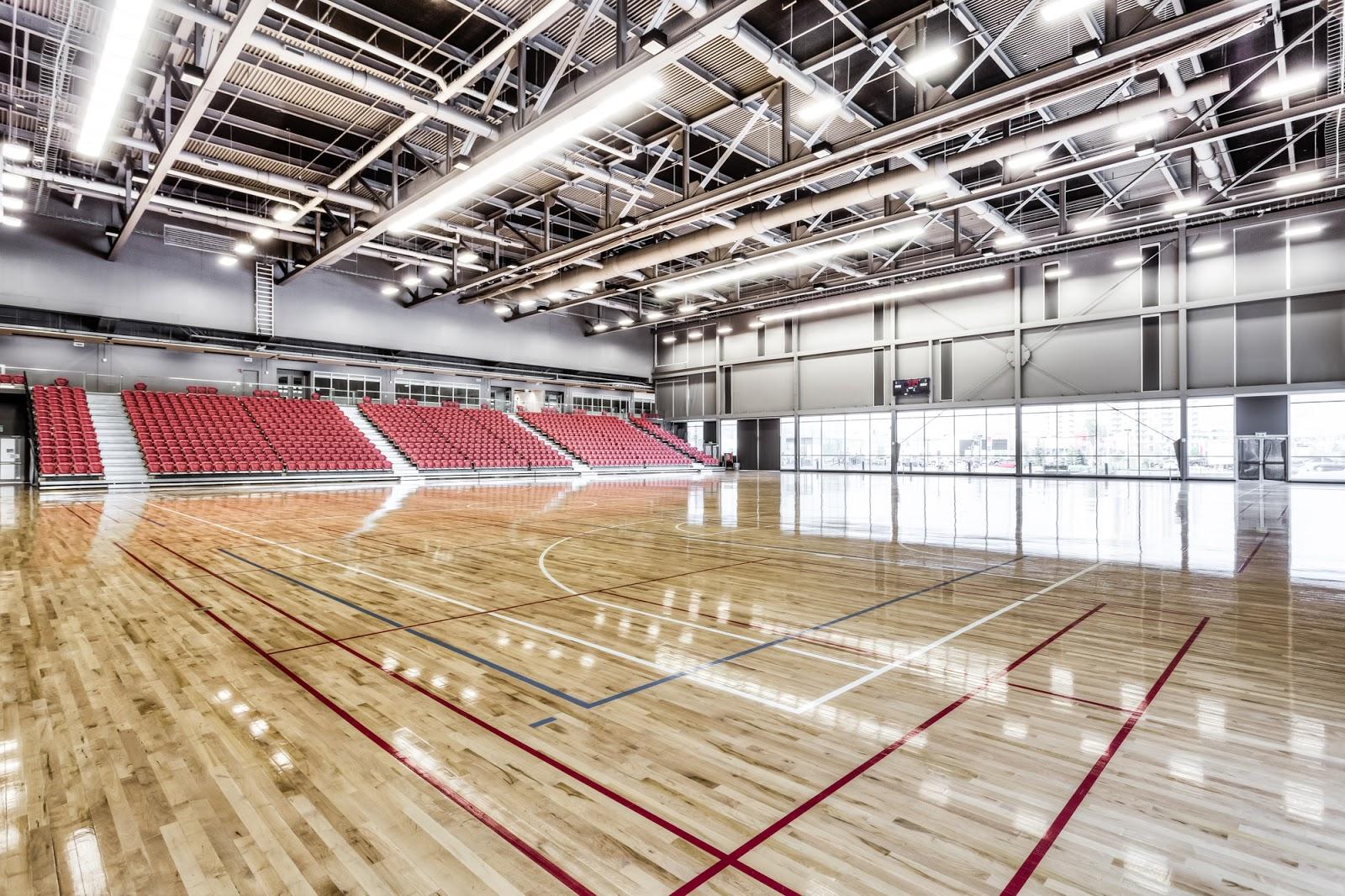 Interior of the Markham Pan Am Centre gymnasium, showing the high steel ceiling, spectator seating and wide window wall