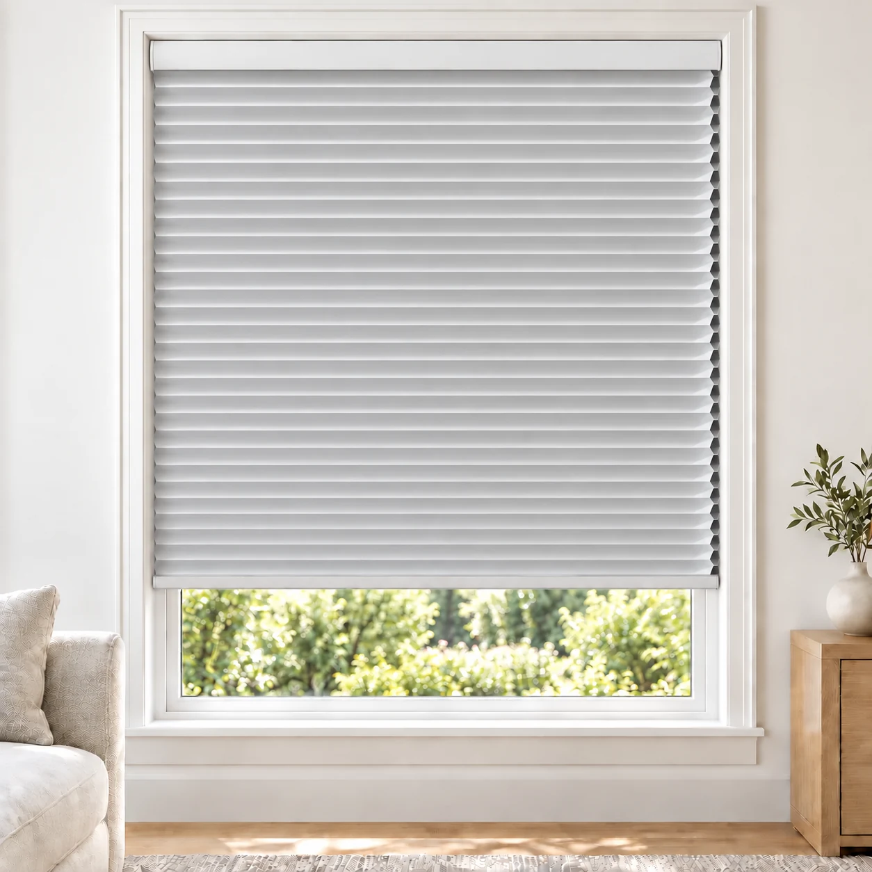 Pearl White 25mm honeycomb cellular blind in a bright neutral living room, fabric B01, blackout