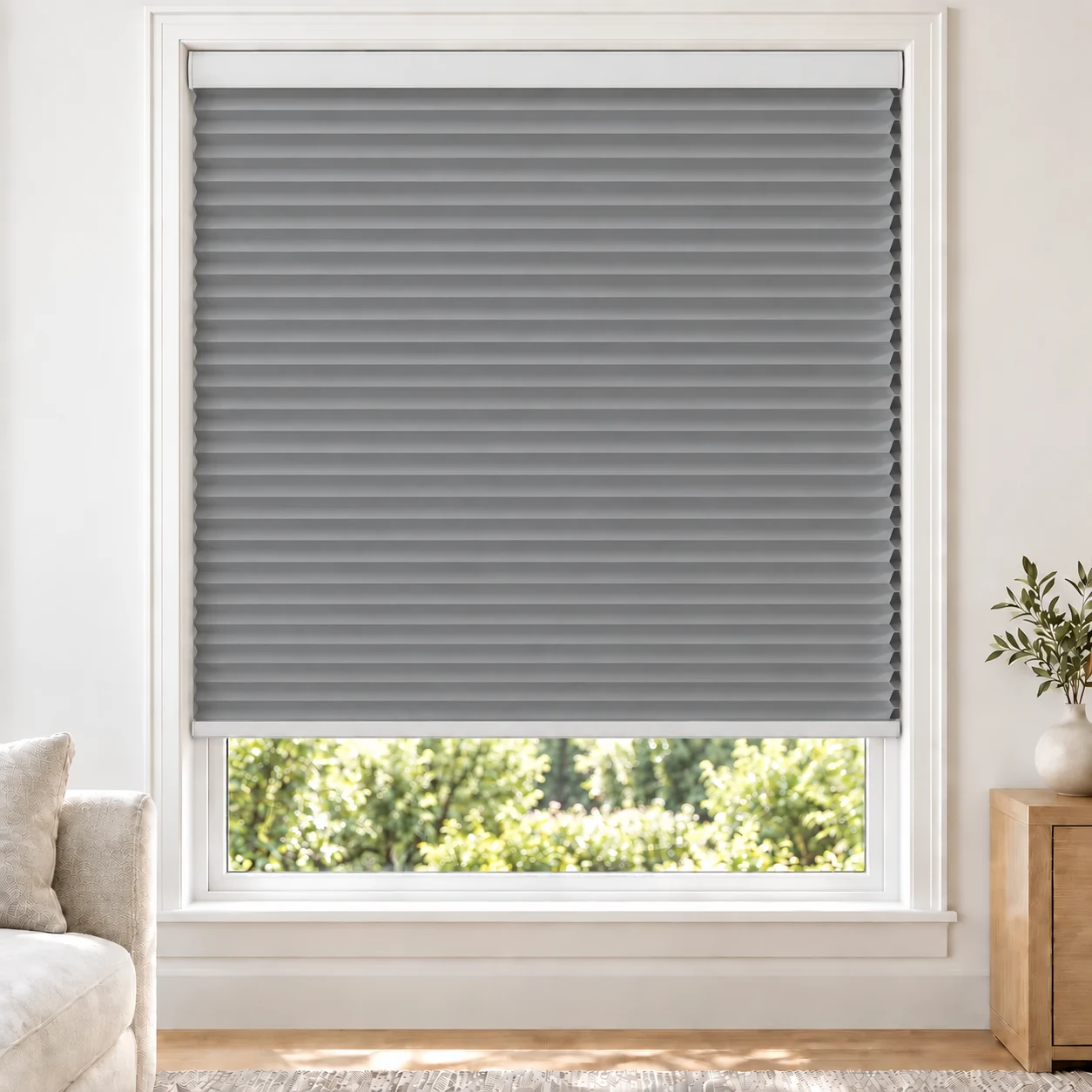Ash Grey 25mm honeycomb cellular blind in a bright neutral living room, fabric B03, blackout