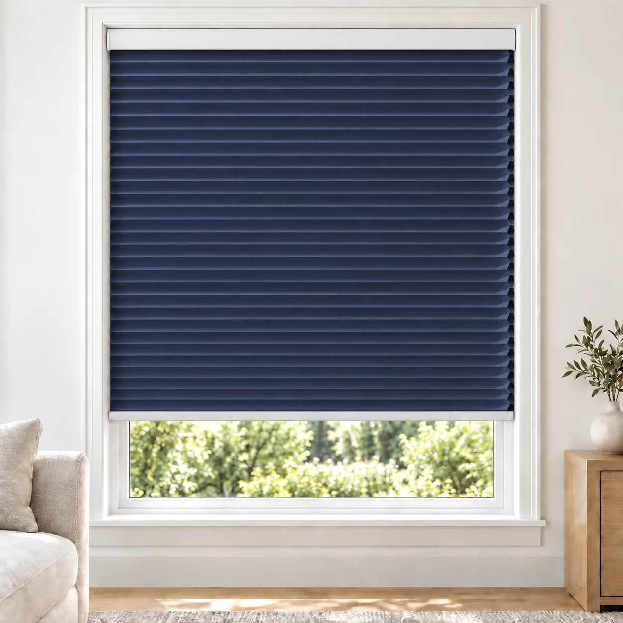 Midnight Blue 25mm honeycomb cellular blind in a bright neutral living room, fabric B04, blackout