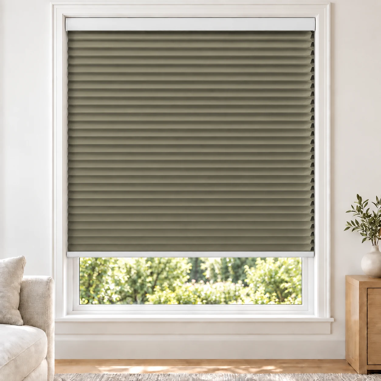 Olive Sand 25mm honeycomb cellular blind in a bright neutral living room, fabric B06, blackout