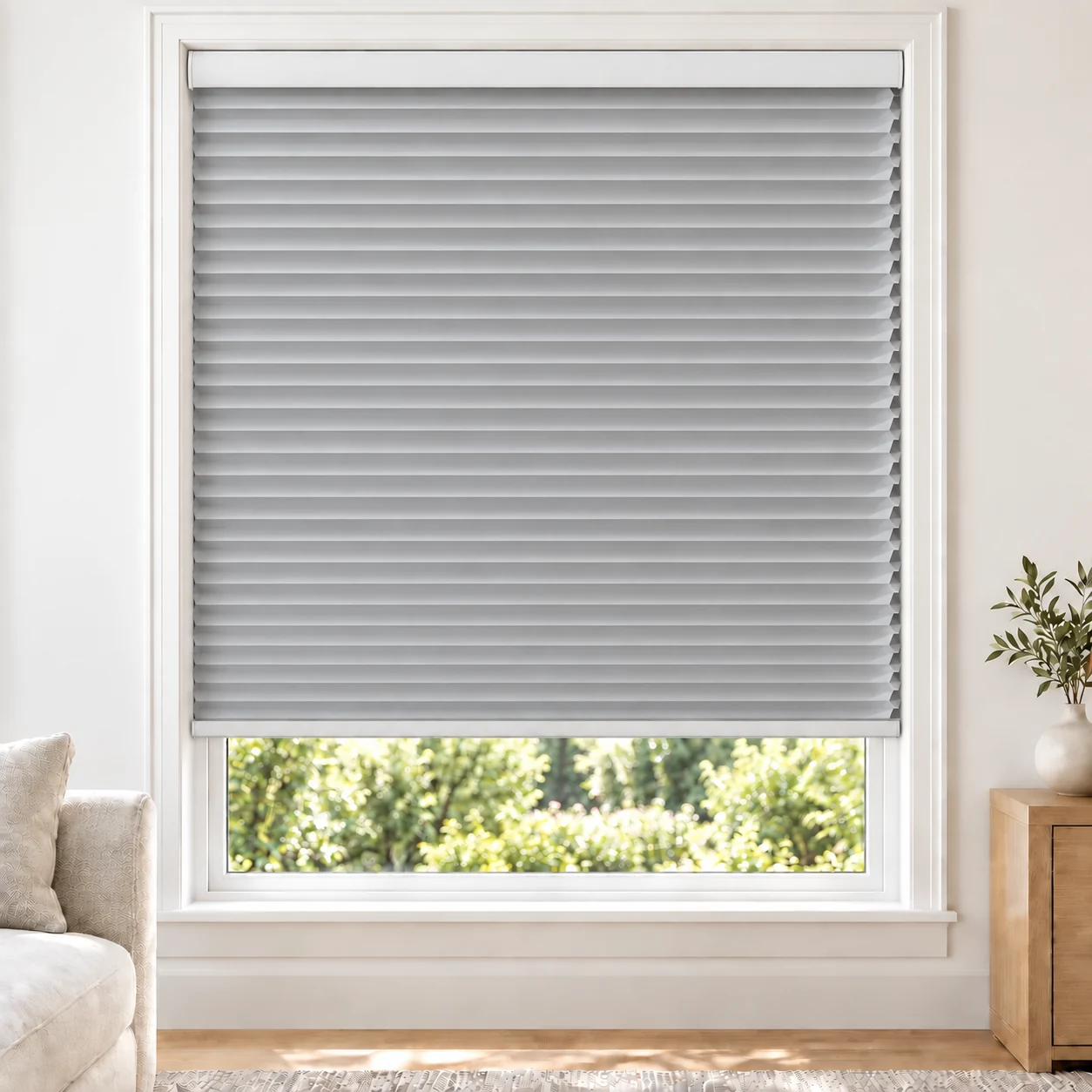 Silver Mist 25mm honeycomb cellular blind in a bright neutral living room, fabric B07, blackout