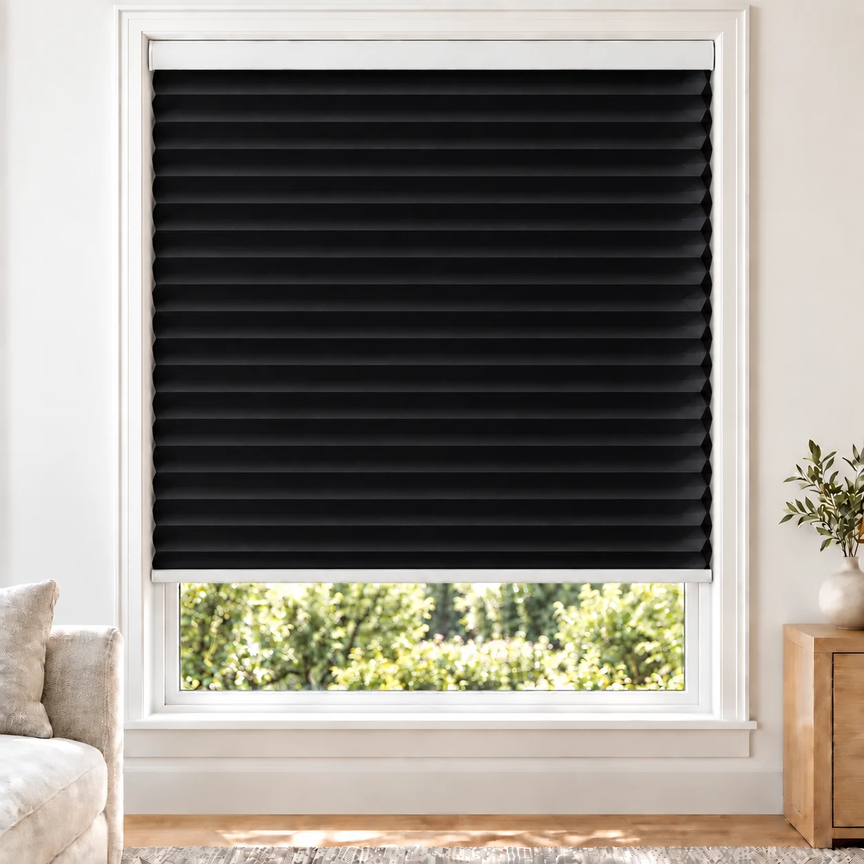 Onyx Black 38mm honeycomb cellular blind in a bright neutral living room, fabric B10-38, blackout
