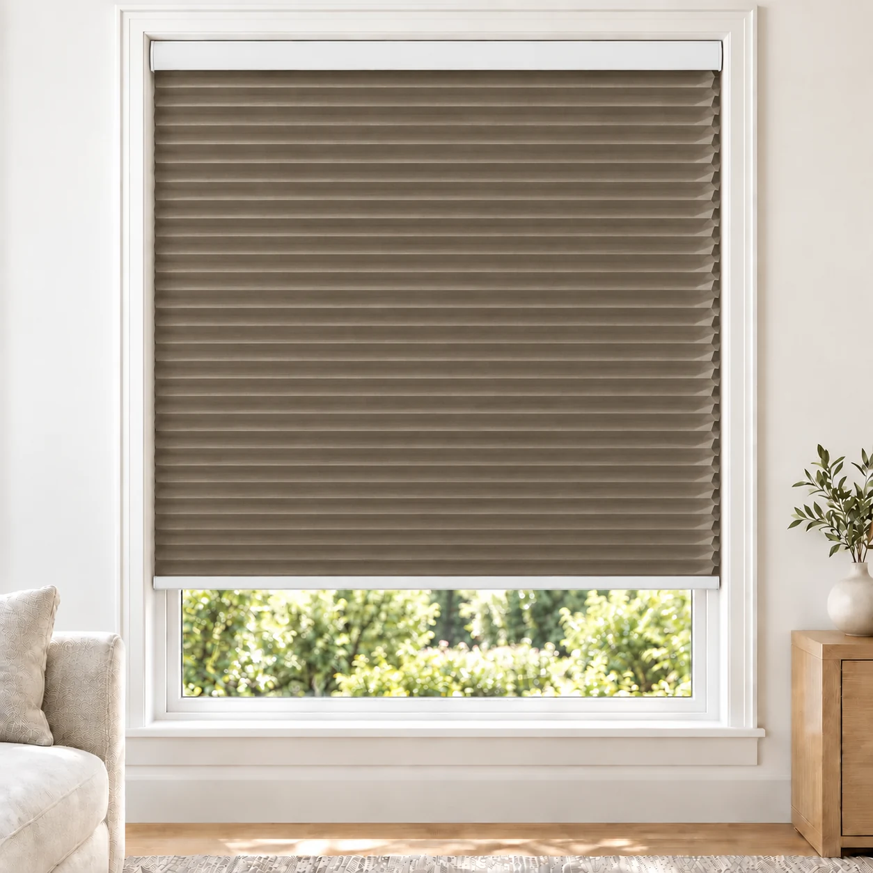 Warm Taupe 25mm honeycomb cellular blind in a bright neutral living room, fabric BTH14, blackout