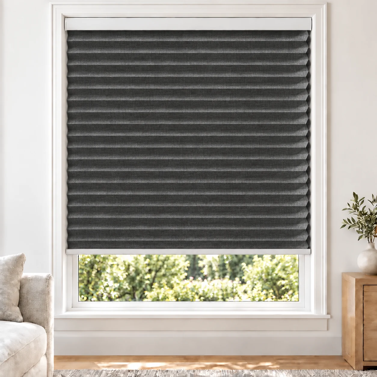 Charcoal Weave 38mm honeycomb cellular blind in a bright neutral living room, fabric BYM03-38, blackout