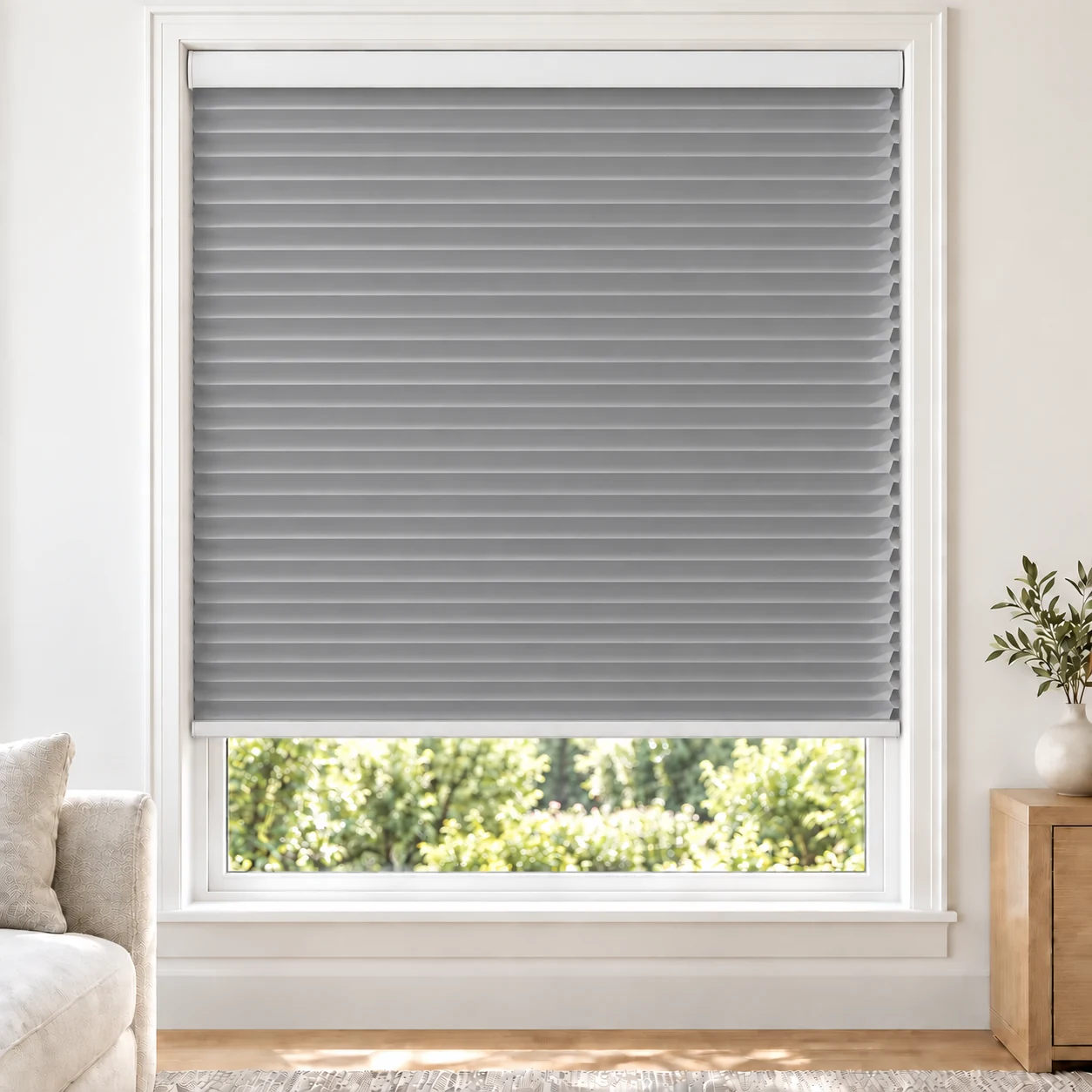 Ash Grey 25mm honeycomb cellular blind in a bright neutral living room, fabric L03, 70% shading