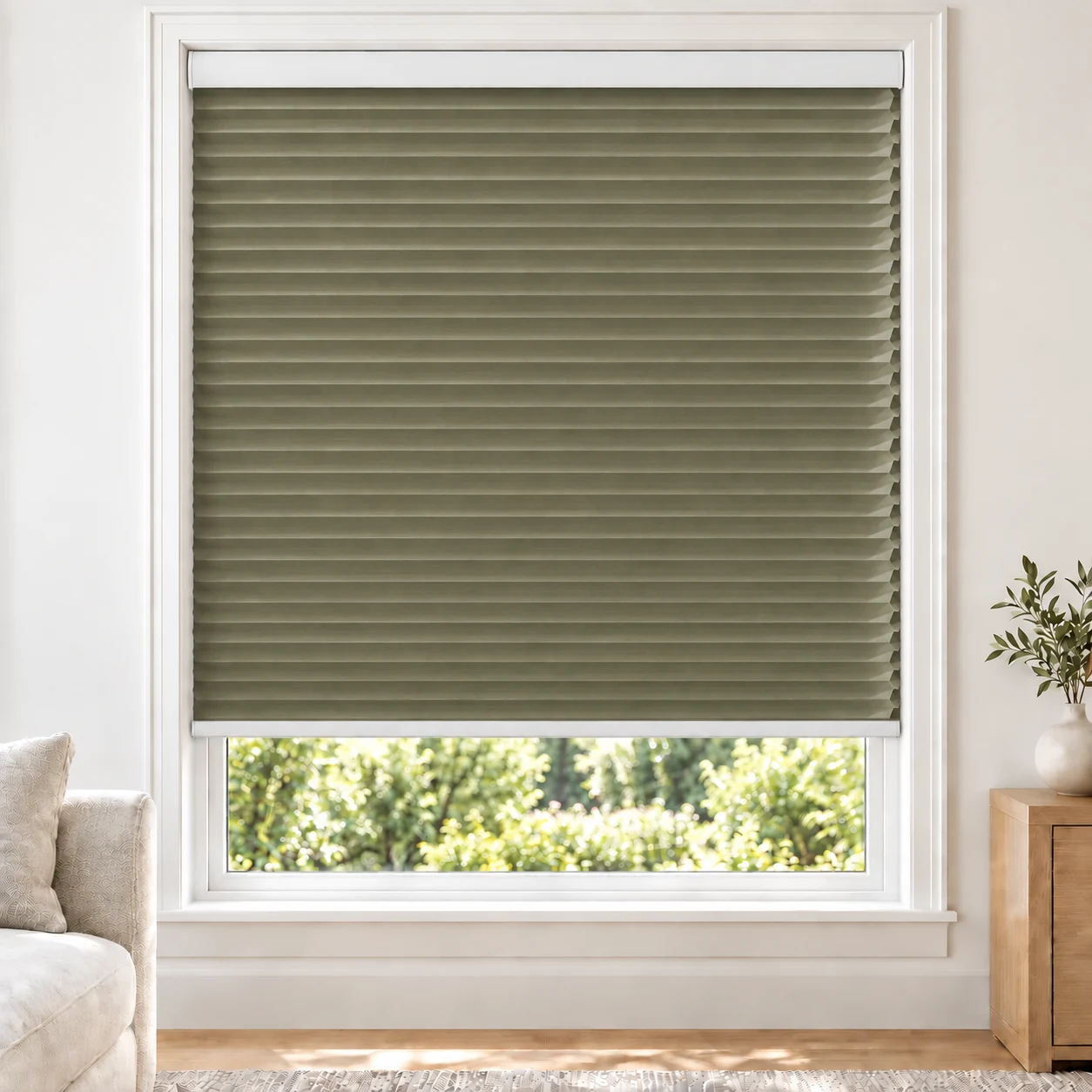 Olive Khaki 25mm honeycomb cellular blind in a bright neutral living room, fabric L06, 70% shading