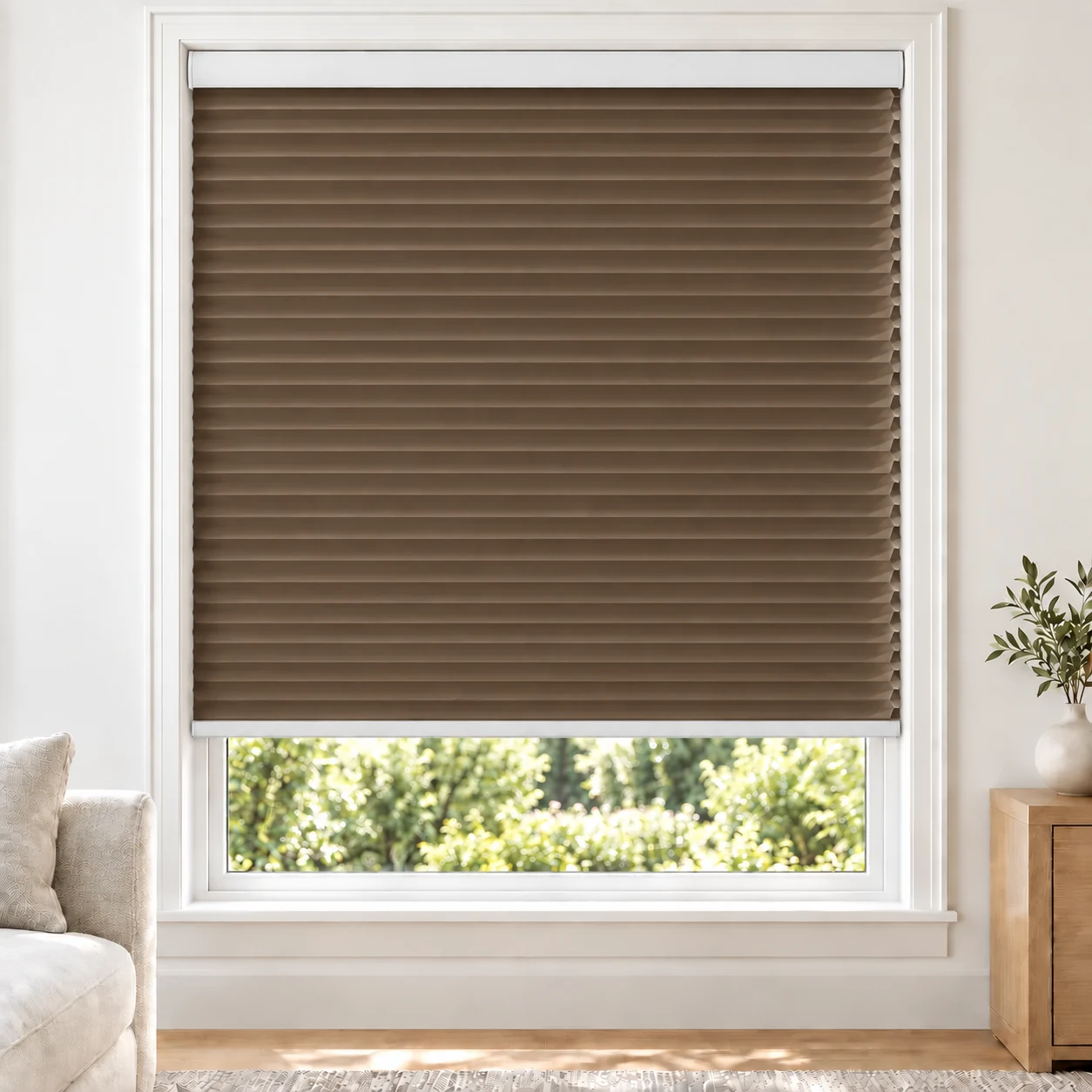 Chestnut 25mm honeycomb cellular blind in a bright neutral living room, fabric L08, 70% shading