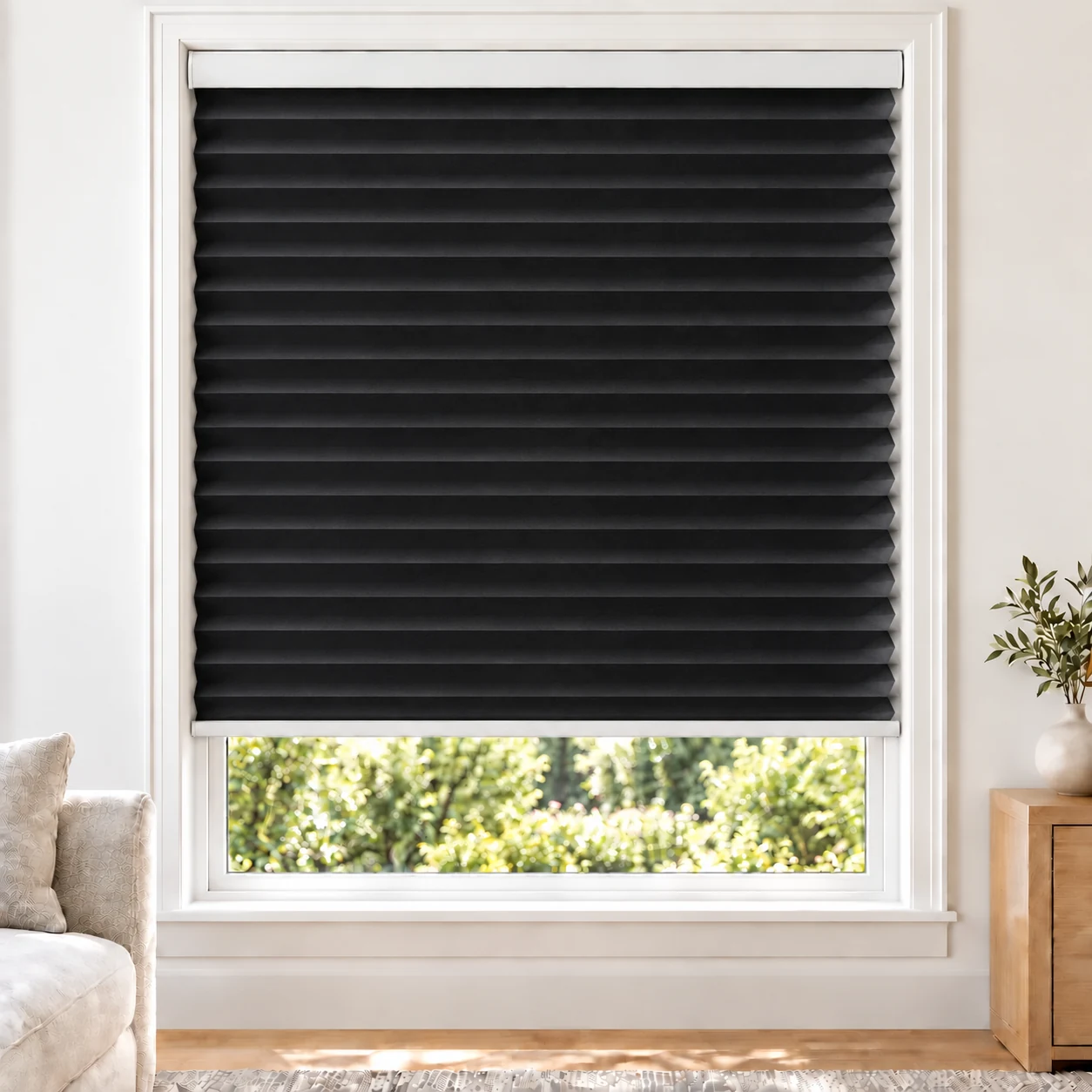 Onyx Black 38mm honeycomb cellular blind in a bright neutral living room, fabric L10-38, 70% shading