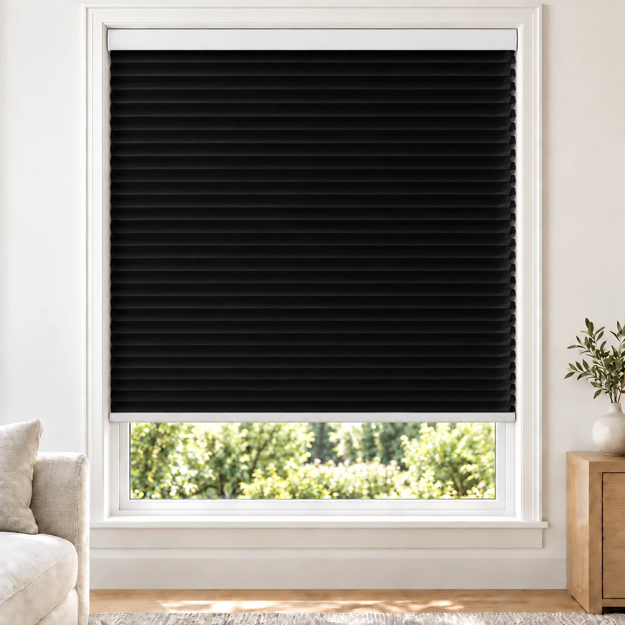 Onyx Black 25mm honeycomb cellular blind in a bright neutral living room, fabric L10, 70% shading