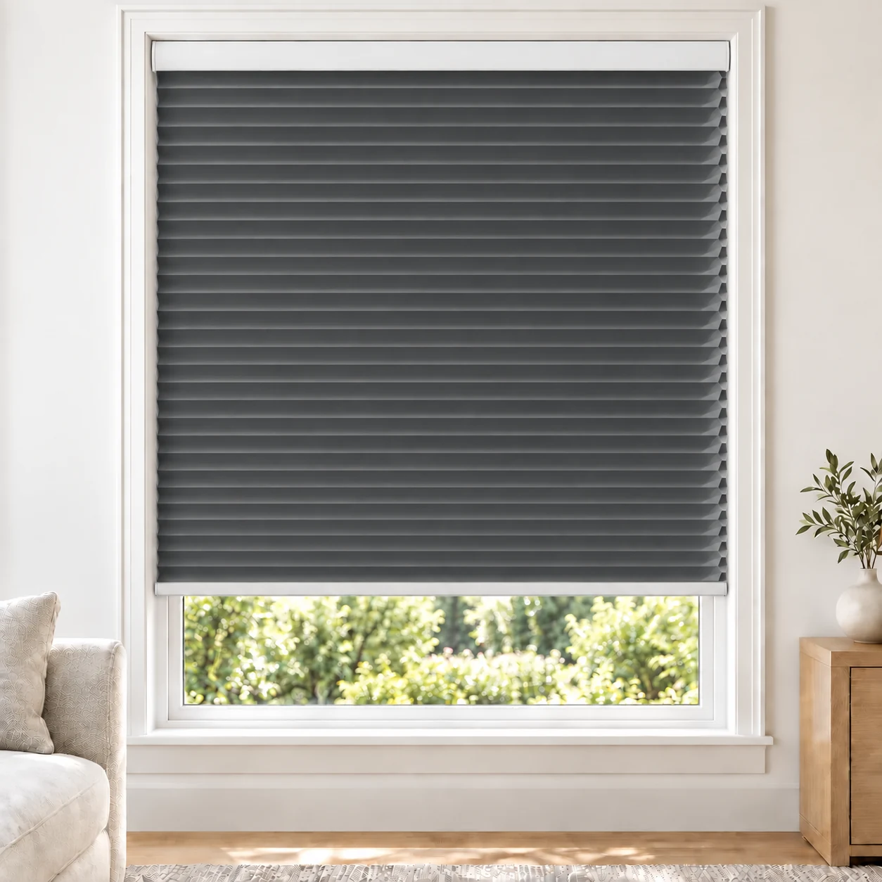 Slate Grey 25mm honeycomb cellular blind in a bright neutral living room, fabric L12, 70% shading