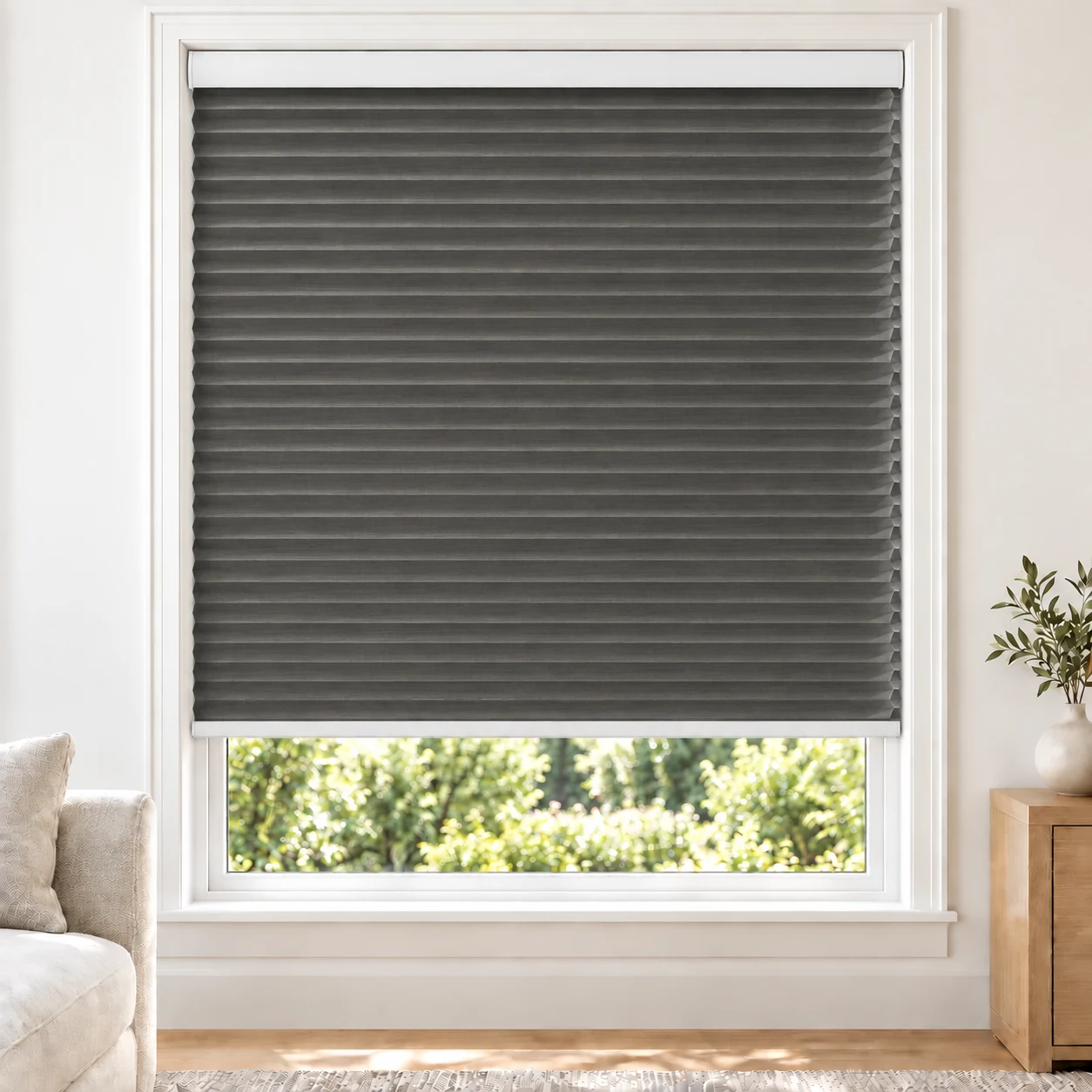 Graphite 25mm honeycomb cellular blind in a bright neutral living room, fabric LTH03, 70% shading