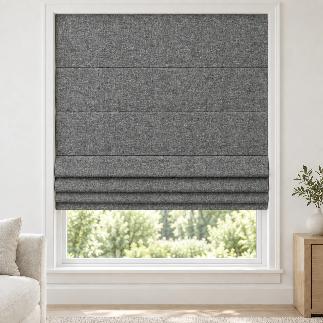 Charcoal cordless Roman shade with a softly textured linen-style weave in a styled living room, blackout, fabric BMF09