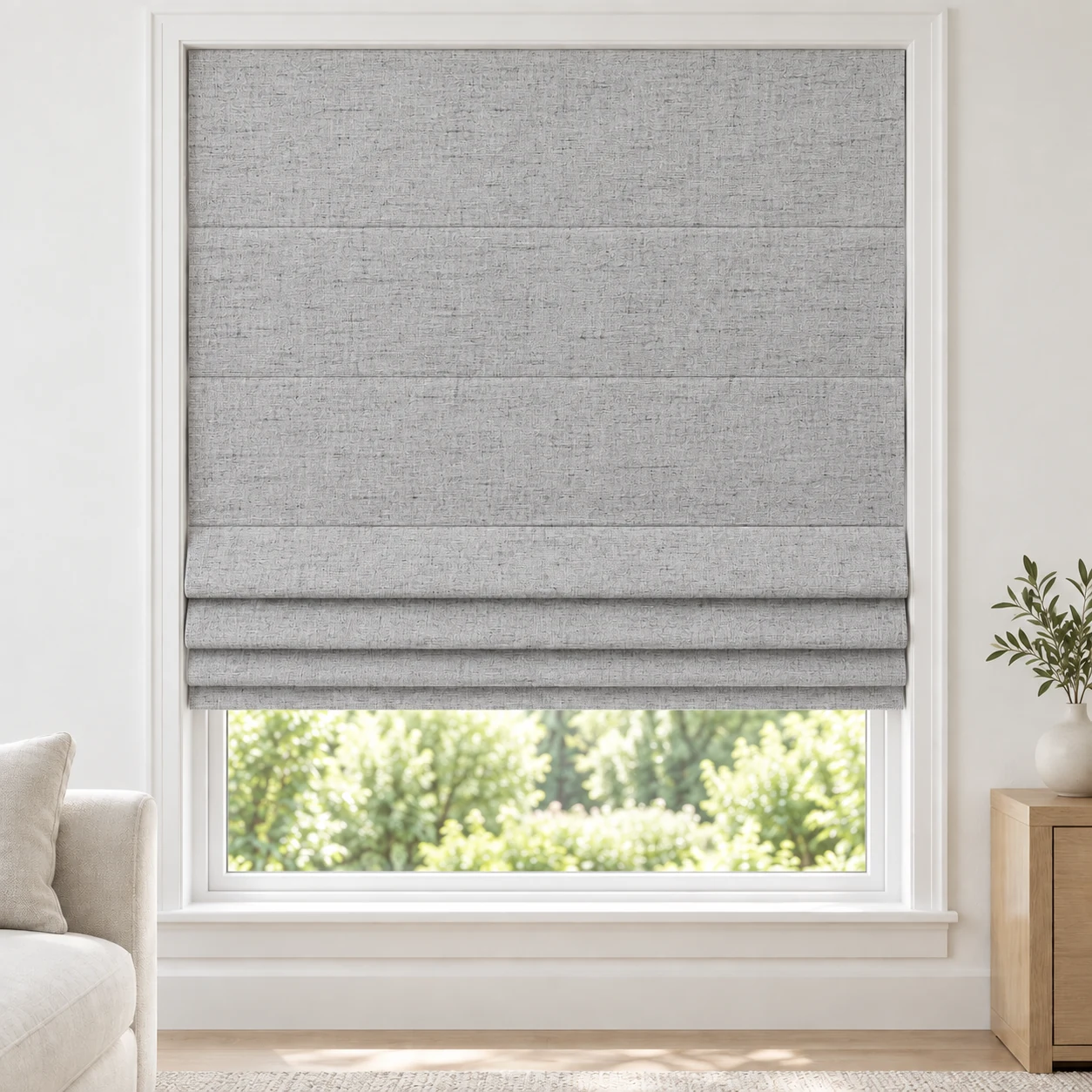 Silver Mist cordless Roman shade with a softly textured linen-style weave in a styled living room, blackout, fabric BMF22