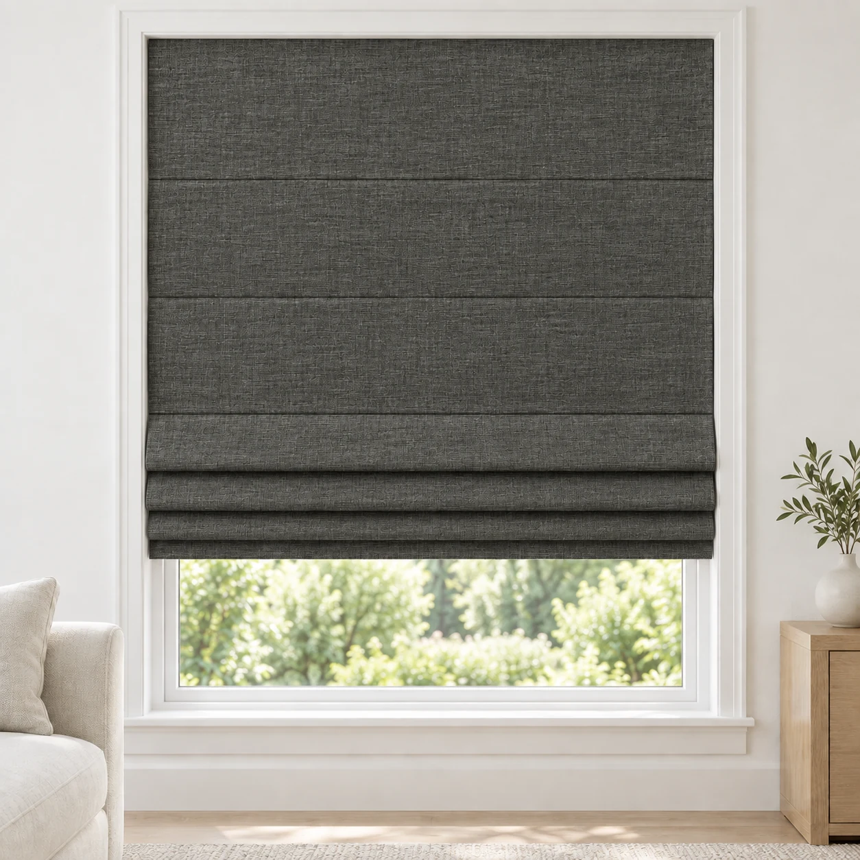 Charcoal cordless Roman shade with a softly layered woven texture in a styled living room, blackout, fabric BML11
