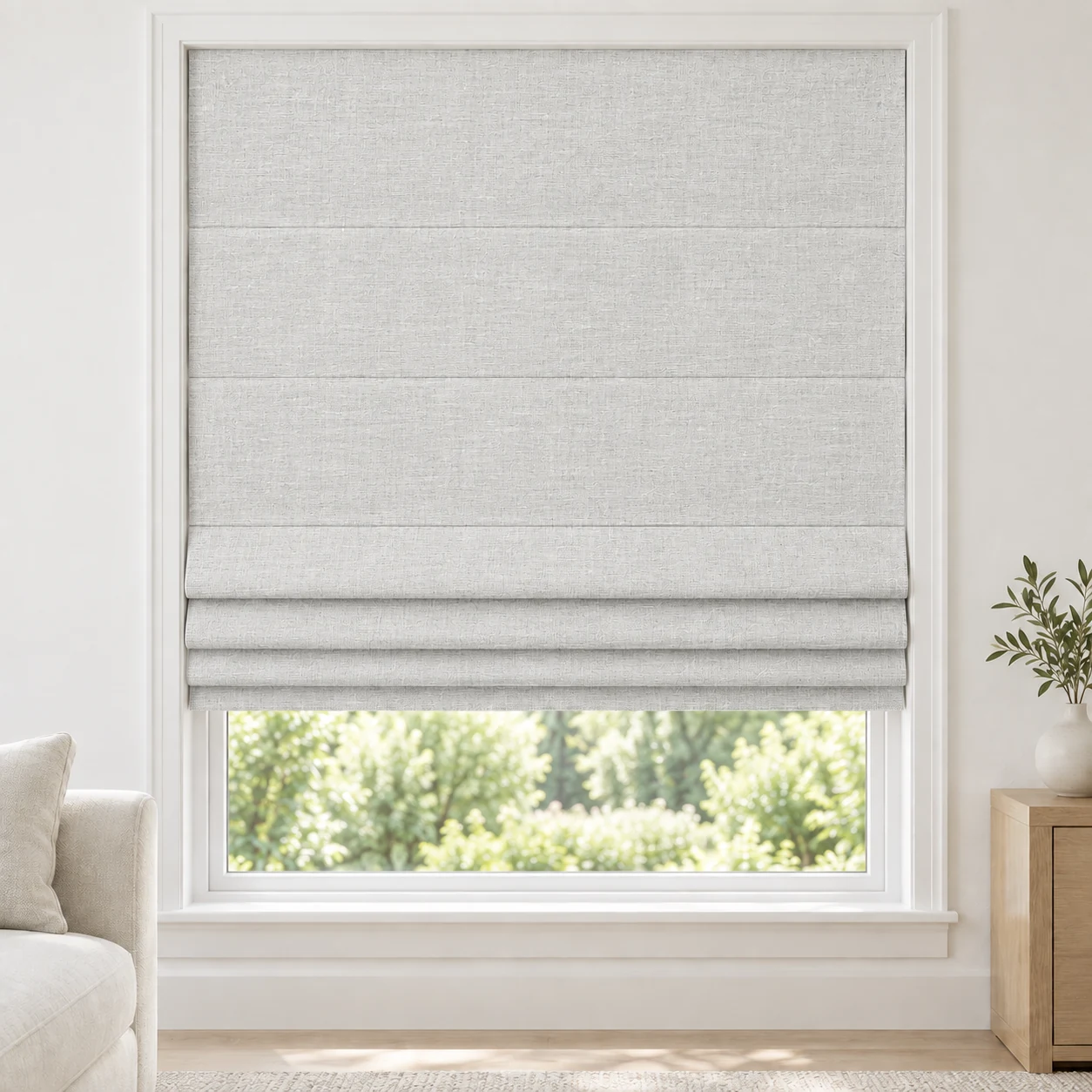 Pearl White cordless Roman shade with a gently striated woven texture in a styled living room, blackout, fabric BMY01