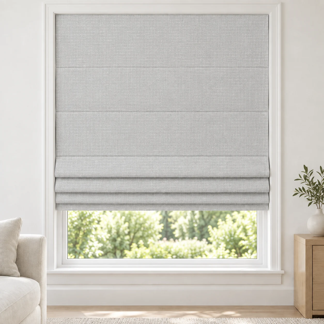 Silver Grey cordless Roman shade with a gently striated woven texture in a styled living room, blackout, fabric BMY03