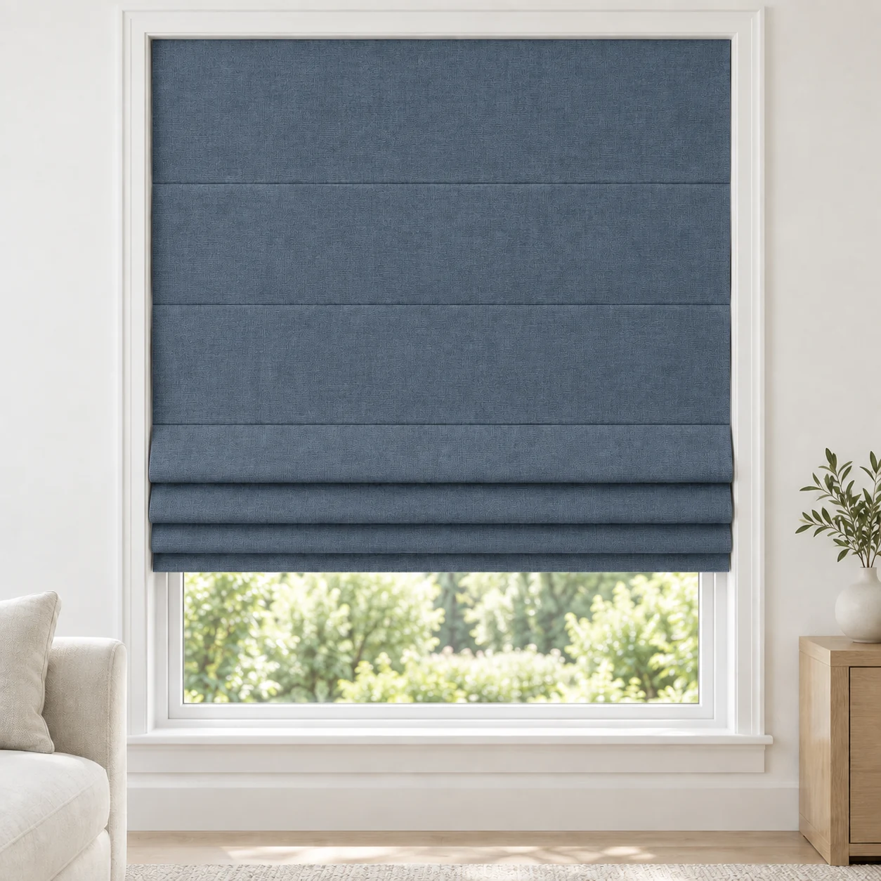Denim Blue cordless Roman shade with a subtle matte texture in a styled living room, blackout, fabric BSY04
