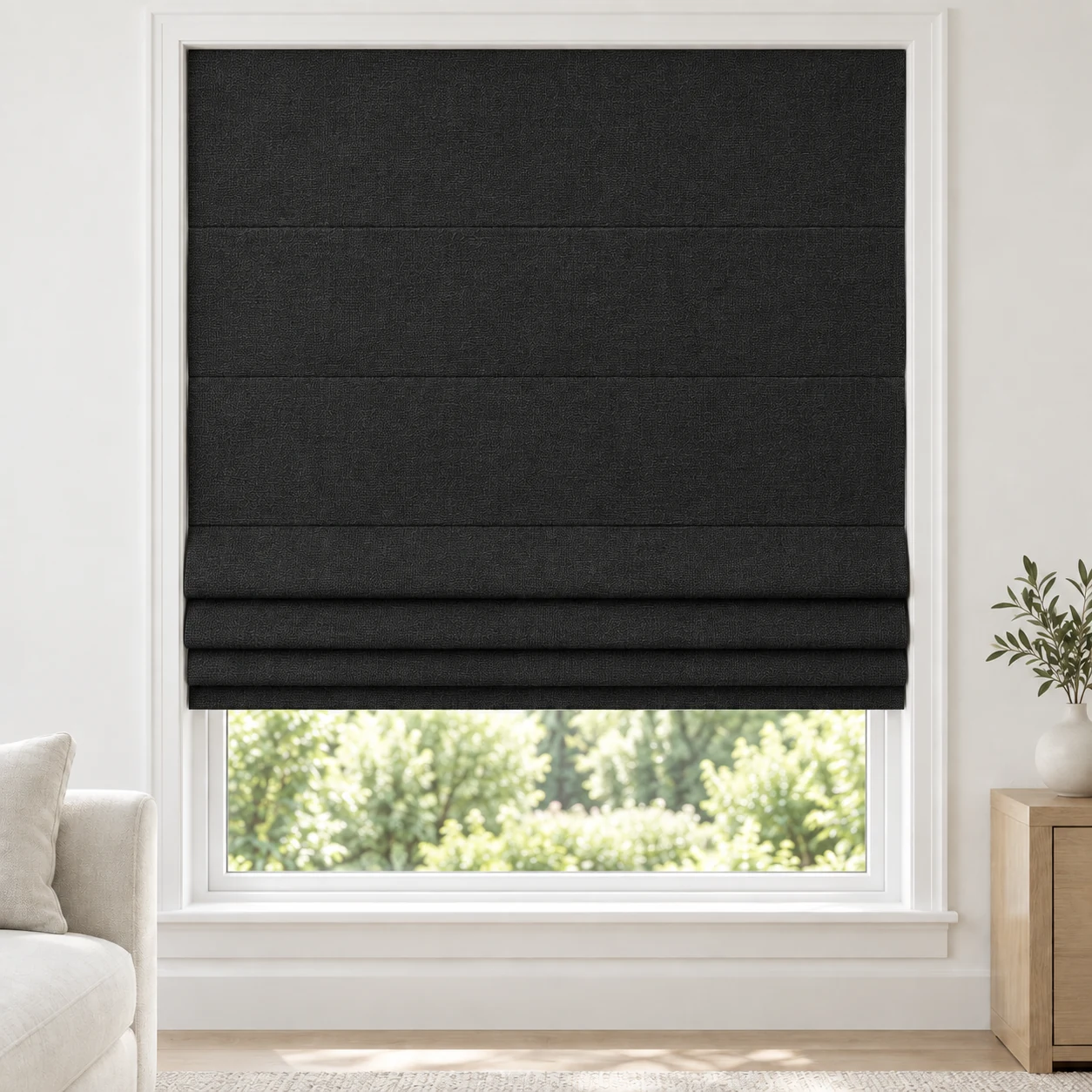 Onyx Black cordless Roman shade with a subtle crosswoven texture in a styled living room, blackout, fabric BTW10