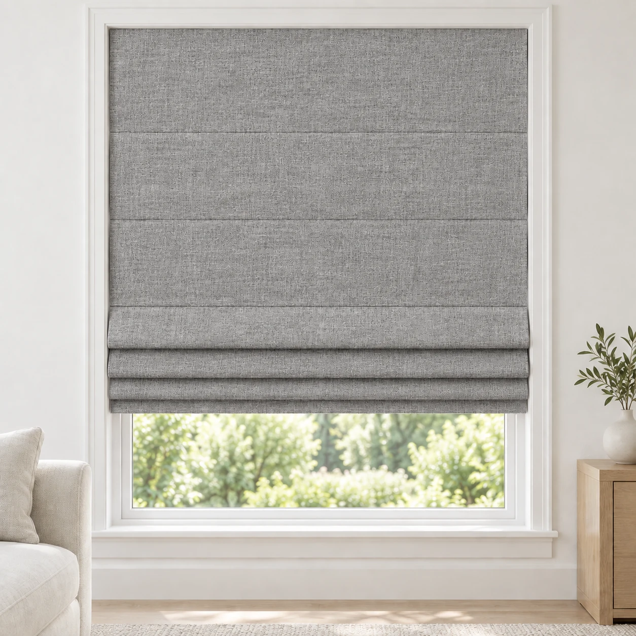 Graphite cordless Roman shade with a fine linen-style weave in a styled living room, blackout, fabric BYM09
