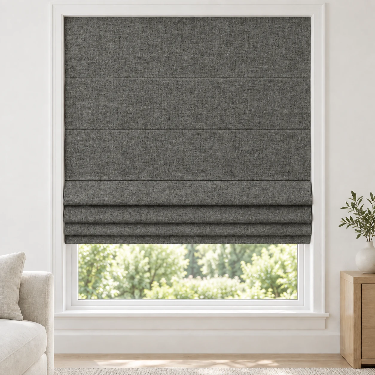 Charcoal cordless Roman shade with a rich, irregular linen-style weave in a styled living room, blackout, fabric BZM09