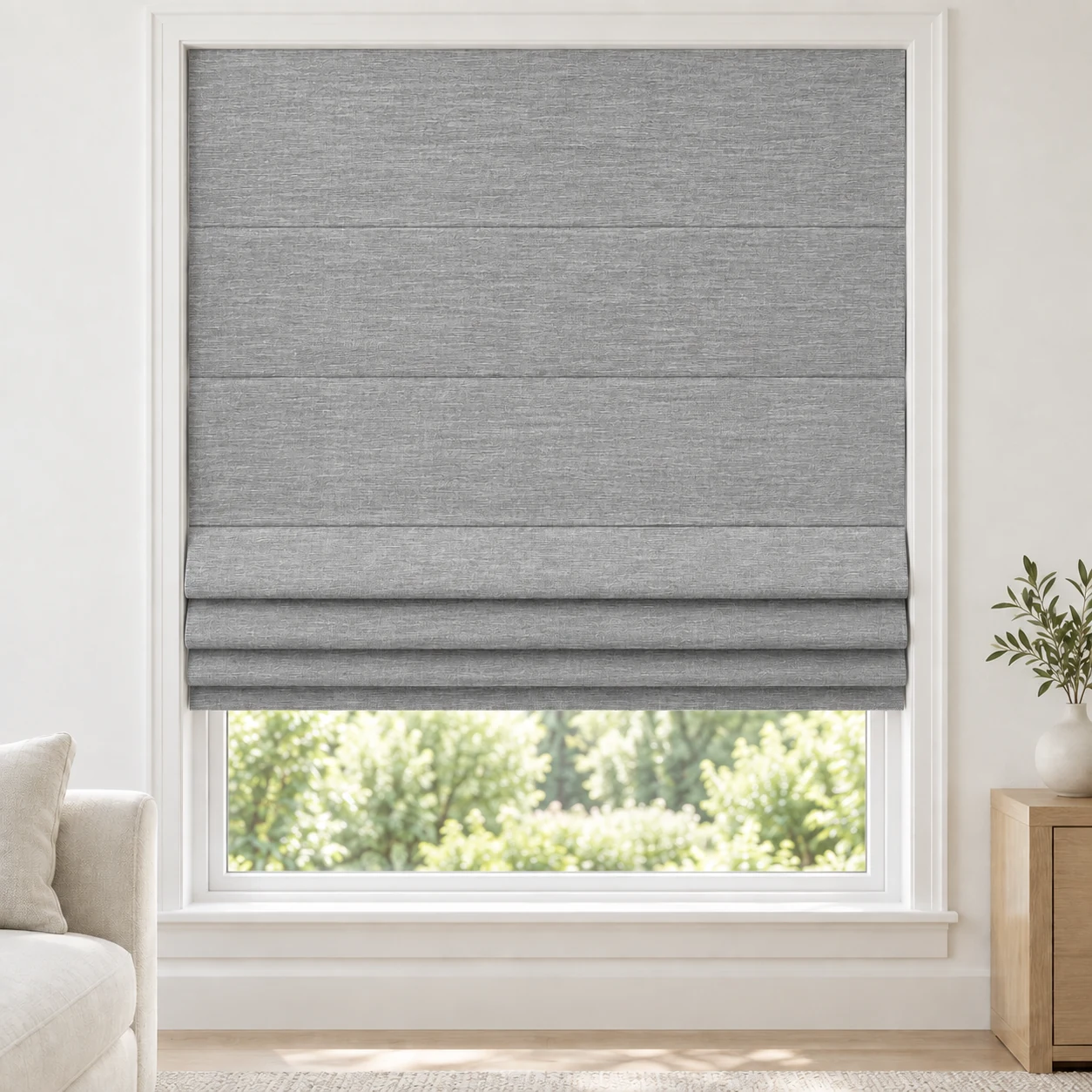 Cool Grey cordless Roman shade with a softly textured open-weave appearance in a styled living room, light filtering, fabric LJMS09
