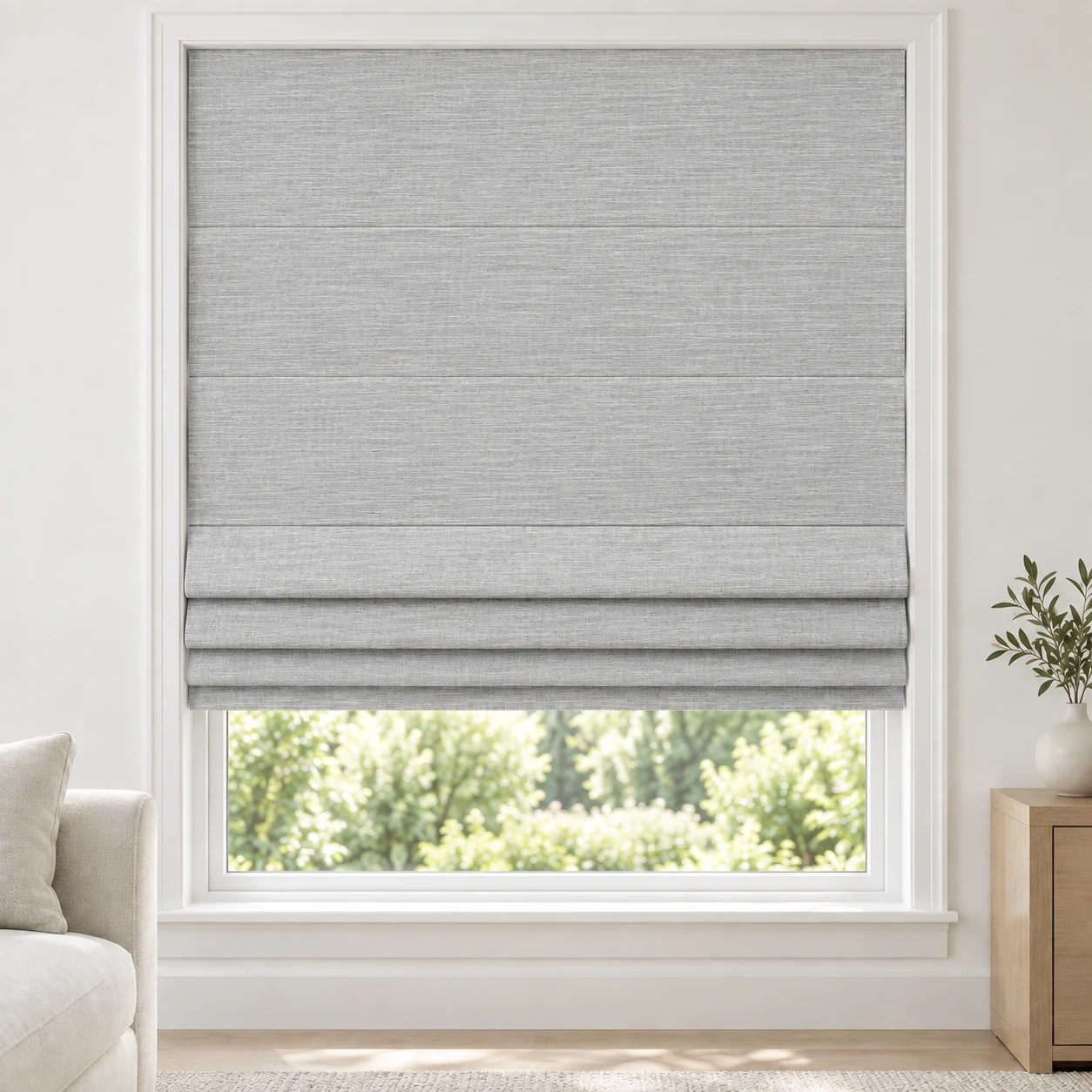 Silver Mist cordless Roman shade with a softly textured open-weave appearance in a styled living room, light filtering, fabric LJMS22