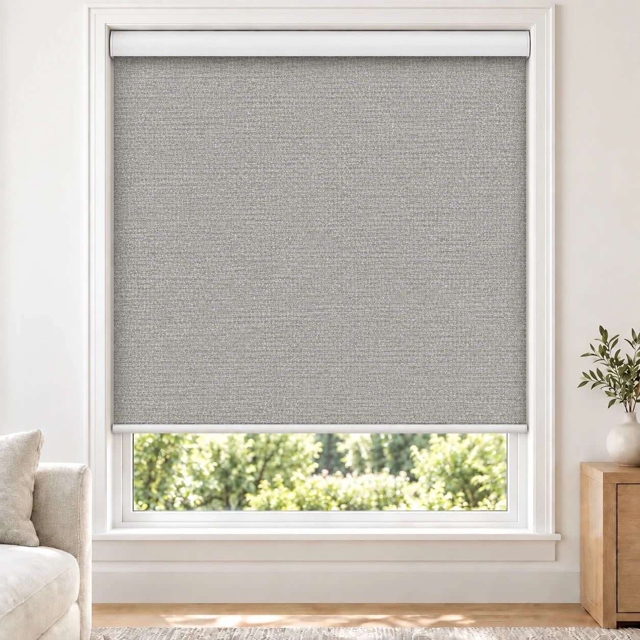 Stone Grey OMEGA3PCT standard roller blind in a bright living room, light filtering, fabric OMEGA3PCT-GREY