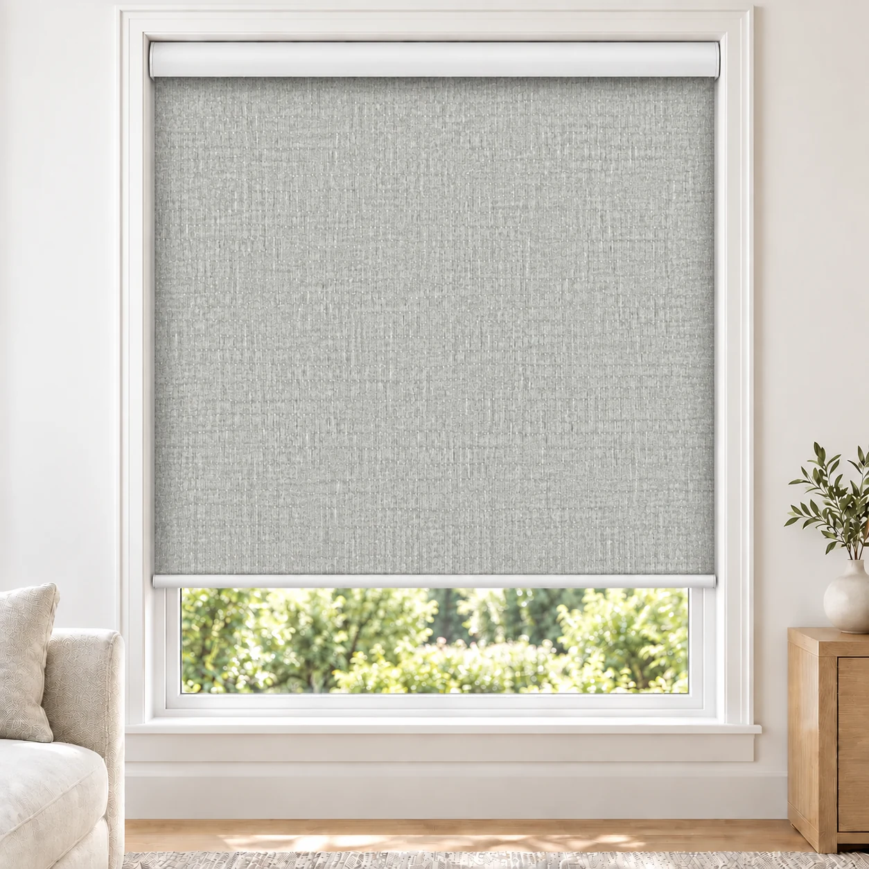 Mist Grey UNIQUE standard roller blind in a bright living room, light filtering, fabric Unique-Light-Grey-LF