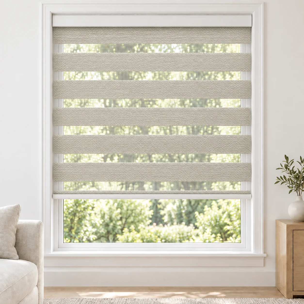 Pure White BLACKLABEL1TONE standard zebra blind with alternating fabric and sheer bands in a bright living room, BLACKLABEL1TONE-PUREWHITE-BO