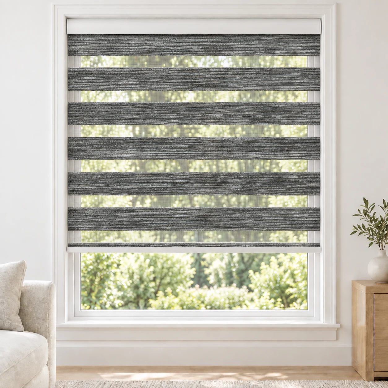Charcoal BLACKLABEL2TONE standard zebra blind with alternating fabric and sheer bands in a bright living room, BLACKLABEL2TONE-CHARCOAL-BO