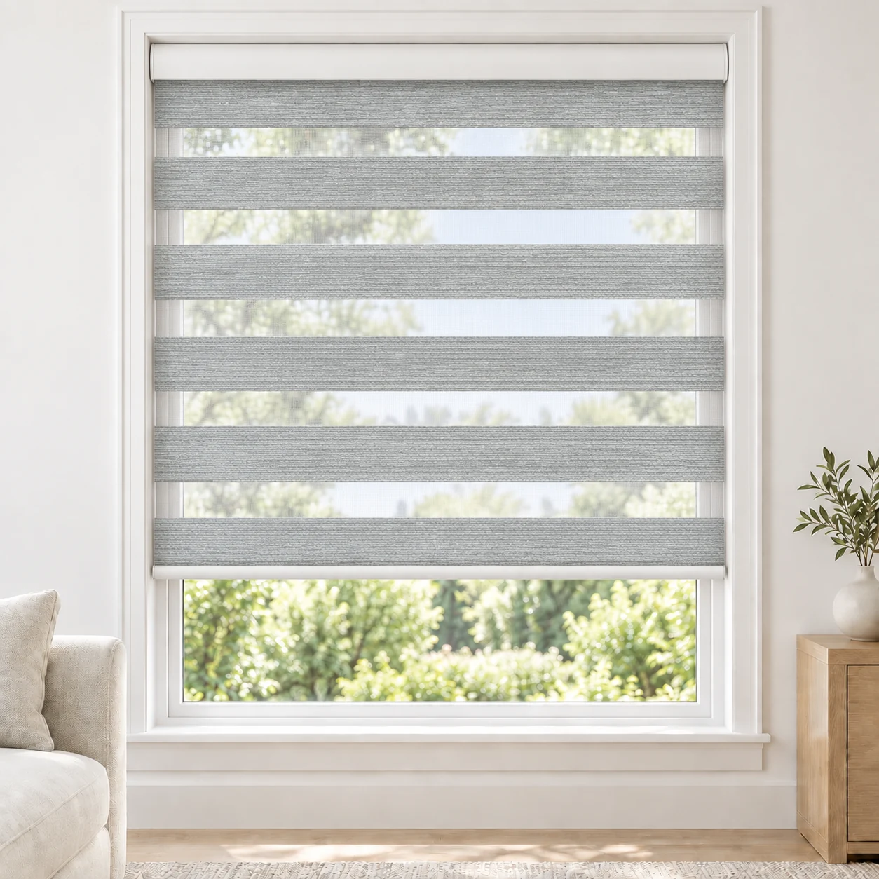 Ice White BLACKLABEL2TONE standard zebra blind with alternating fabric and sheer bands in a bright living room, BLACKLABEL2TONE-ICEWHITE-BO