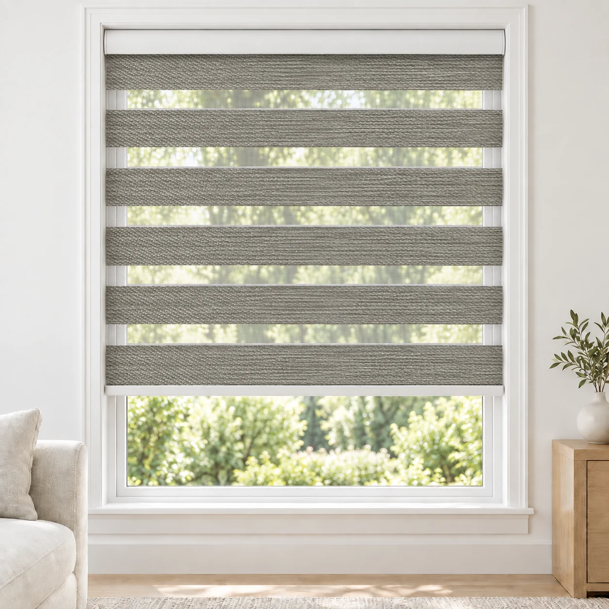 Mist Grey Bophia standard zebra blind with alternating fabric and sheer bands in a bright living room, Bophia-Light-Grey-DO