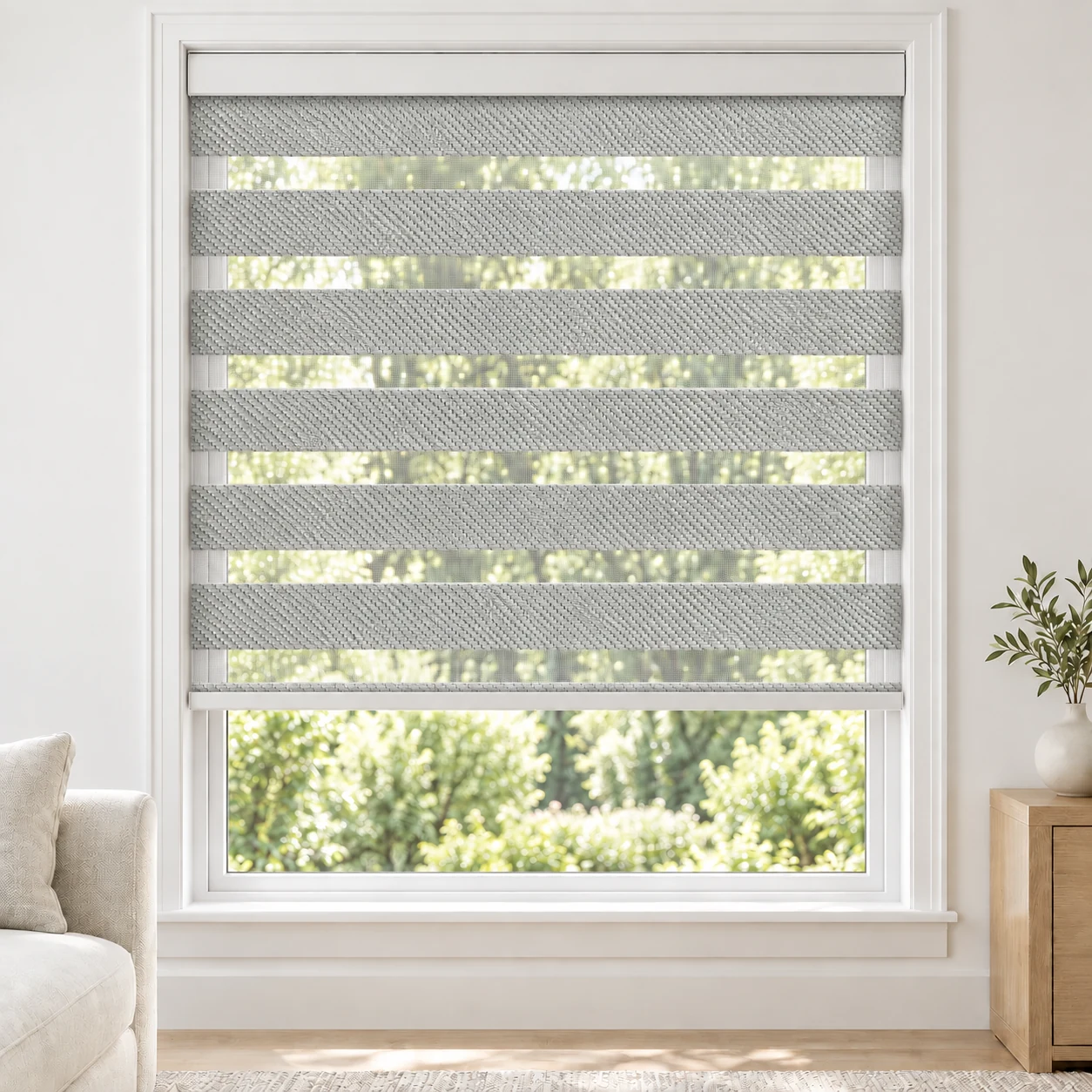 Stone Grey FARO standard zebra blind with alternating fabric and sheer bands in a bright living room, FARO-GRAY-BO