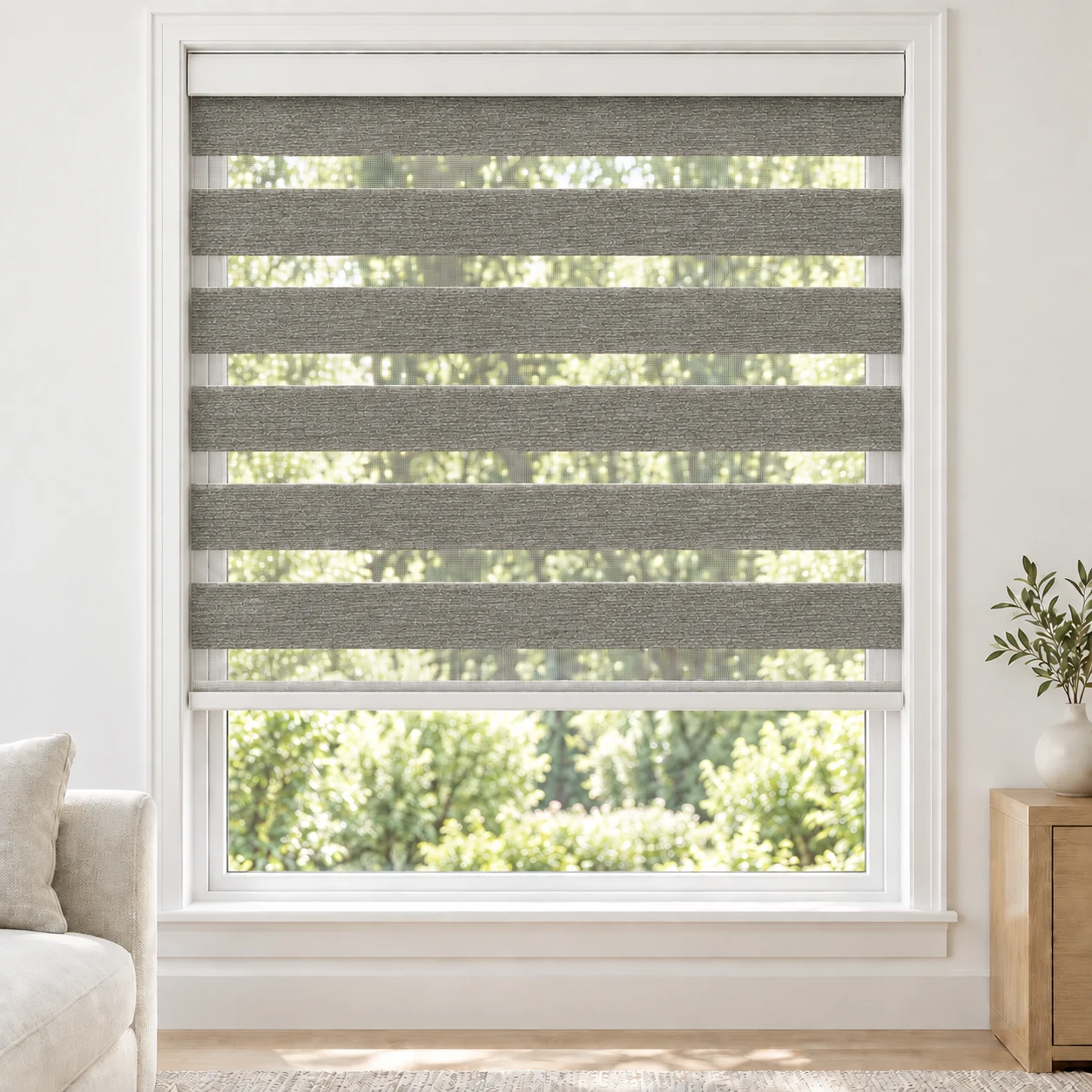 Stone Grey LANA standard zebra blind with alternating fabric and sheer bands in a bright living room, LANA-GERY-LF