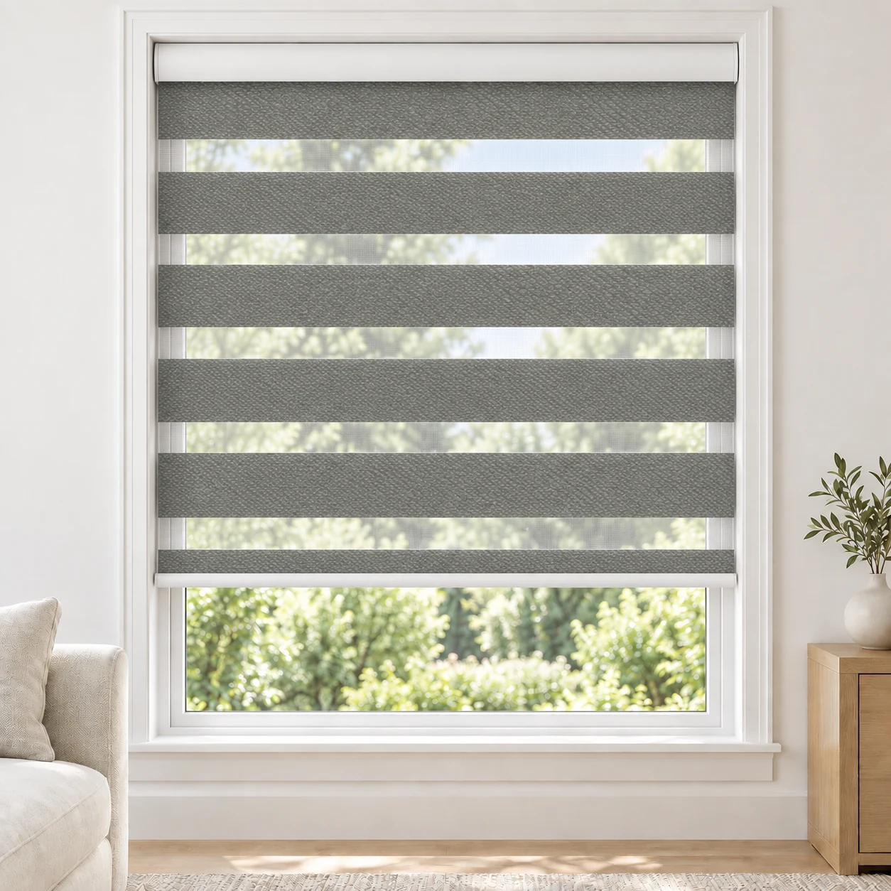 Silver Grey LOUIA standard zebra blind with alternating fabric and sheer bands in a bright living room, LOUIA-SLIVER-LF