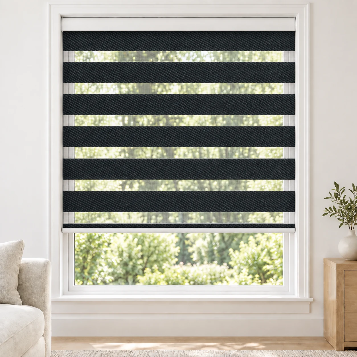 Onyx Black NOGUCHI standard zebra blind with alternating fabric and sheer bands in a bright living room, NOGUCHI-BLACK-BO