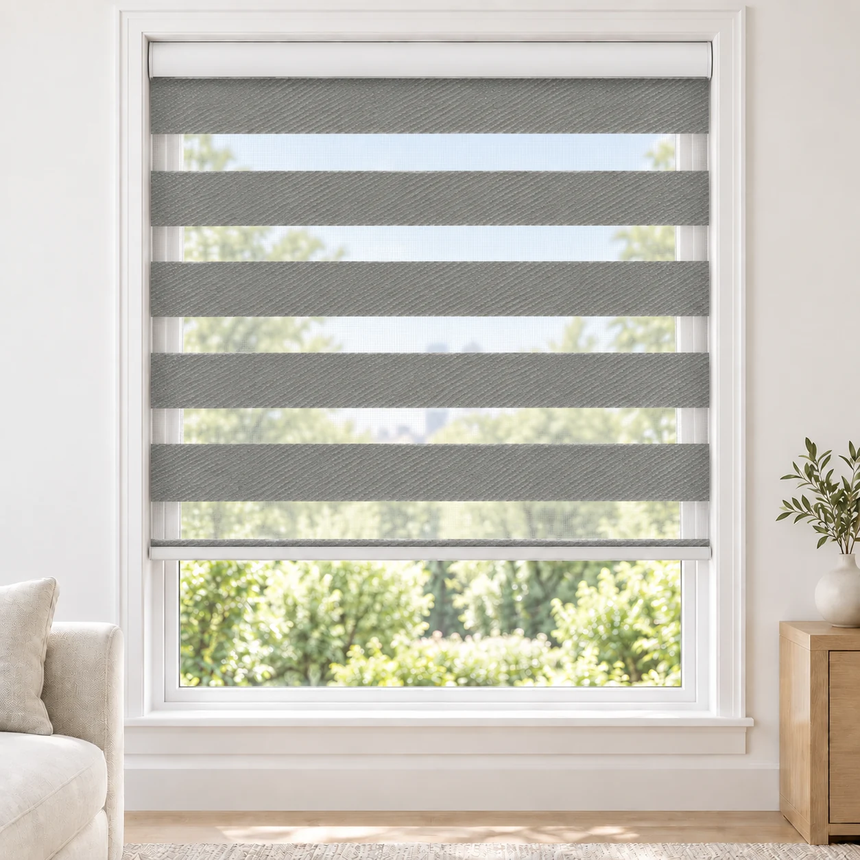 Navy NOGUCHI standard zebra blind with alternating fabric and sheer bands in a bright living room, NOGUCHI-NAVY-BO