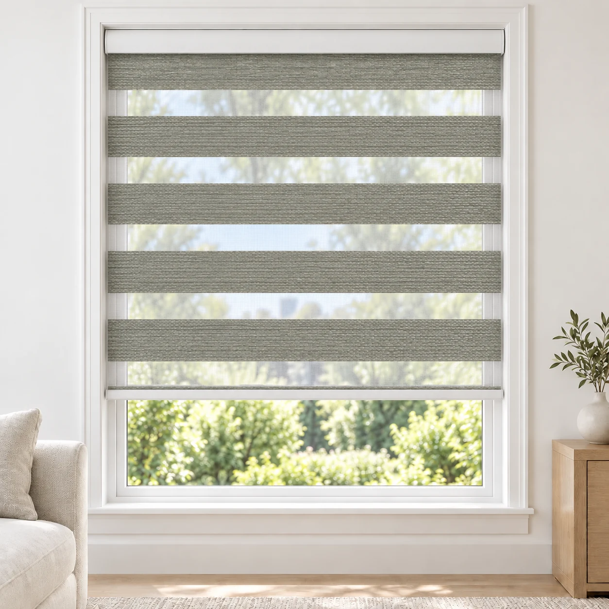 Stone Grey Rossini standard zebra blind with alternating fabric and sheer bands in a bright living room, Rossini-06-DO