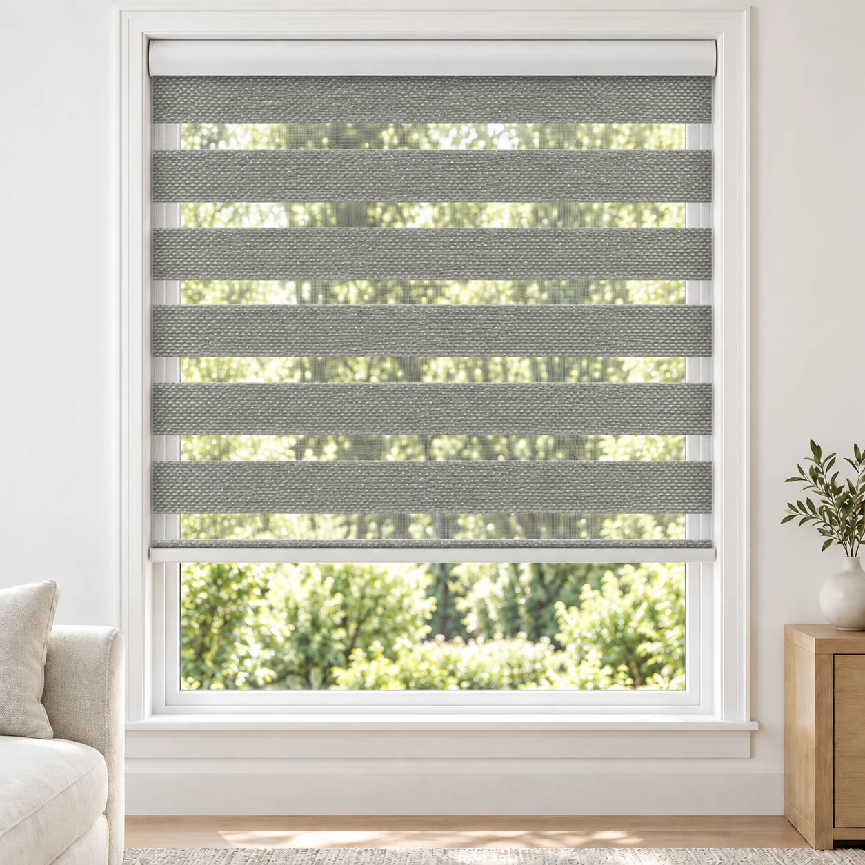 Pewter Grey XZ74B standard zebra blind with alternating fabric and sheer bands in a bright living room, XZ74B-5-DO